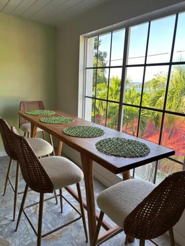 a dining room with two tables and chairs and a window at The Mary Anne Boutique Hotel USVI in Charlotte Amalie