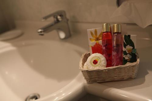 a basket on a sink next to a sink at Hotel Petit Prince in Antagnod