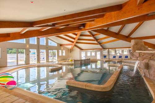 a large indoor swimming pool in a house at Le Phare in Les Portes