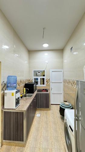 a large room with a kitchen with a counter top at Rukn Barka in Barka
