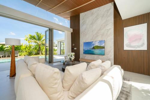 a living room with a white couch and a table at Luxury villa 3-4 bedroom near Bangtao beach in Phuket Town