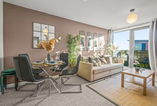 a living room with a table and a couch at Pan Asian Haven with Balcony with CityView and Free Parking in Birmingham
