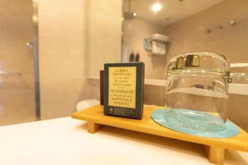 a sign on a wooden shelf with a glass container at Terrado Suites Antofagasta in Antofagasta