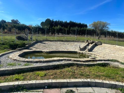a pond in the middle of a field at Casa Syria in Potenza