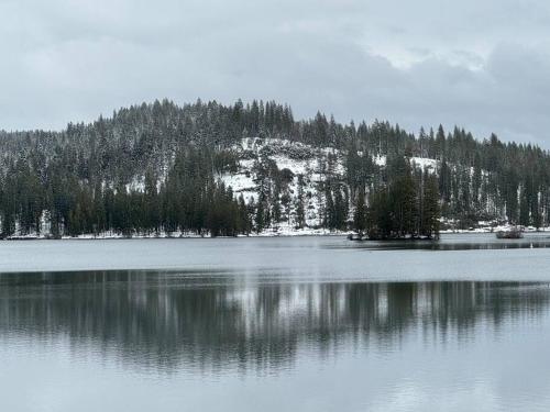 a large body of water with a mountain in the background at Family get away Near Sly Park Lake & Apple Hill in Pollock Pines