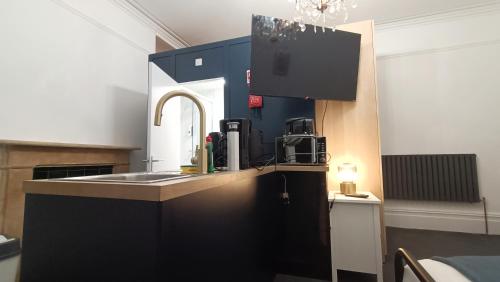 a kitchen with a sink and a counter top at Fulforth St Studio Apartments in Nottingham