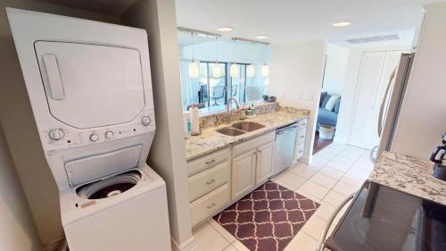 a large bathroom with a washer and dryer in it at Getaway to the Beach 2 Bdrm Villa with Amenities in Pawleys Island