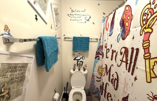 a bathroom with a toilet and a wall covered in stickers at Disney Wonderland Suite at Jiminy-Ski On Off Mtn - Must See Stitch and Mickey Magic in Hancock
