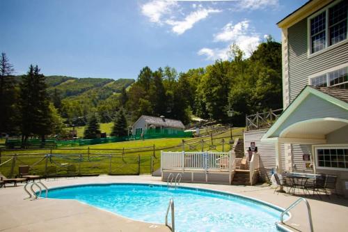 a swimming pool in front of a house at Disney Wonderland Suite at Jiminy-Ski On Off Mtn - Must See Stitch and Mickey Magic in Hancock
