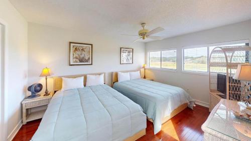 a bedroom with two beds and a window at Getaway to the Beach 2 Bdrm Villa with Amenities in Pawleys Island