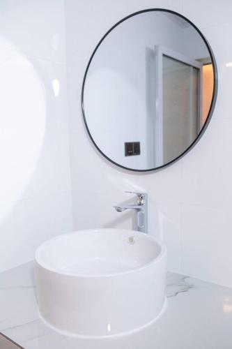 a bathroom with a white sink and a mirror at Rangali thoddoo Maldives in Thoddoo