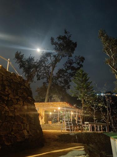 a night view of a building with a moon in the sky at The Sweven NeerVan in Rishīkesh
