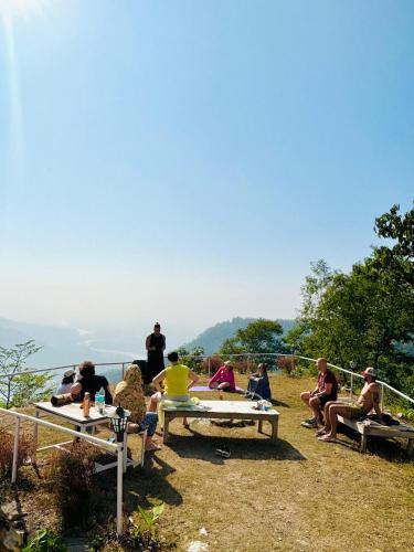 a group of people sitting around a picnic table at The Sweven NeerVan in Rishīkesh