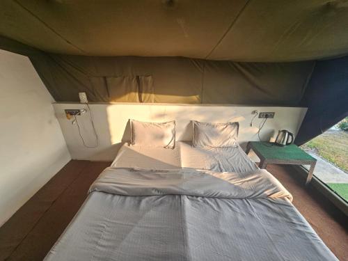 a large bed in a room with a tent at The Sweven NeerVan in Rishīkesh