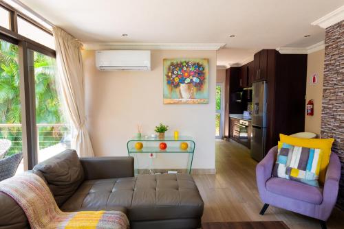 a living room with a couch and a chair at Ekuthuleni Modern Christian Guesthouse with seaview in Umhlanga Ridge