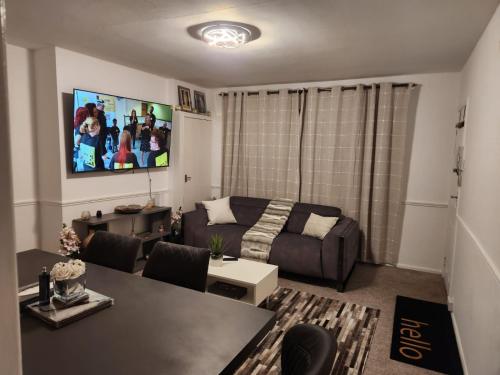 a living room with a couch and a table at Dmltd in Northampton