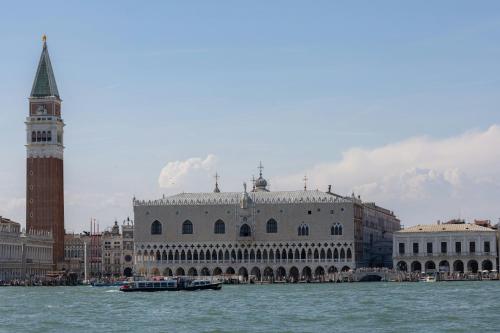 a large building with a clock tower on the water at San Marco Loft in Venice