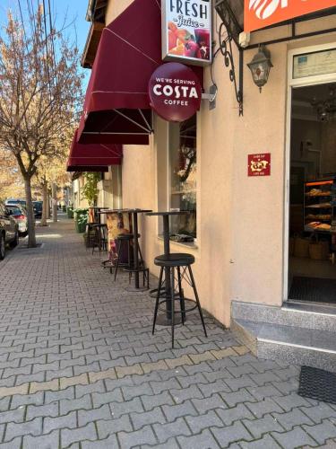 a cafe with a table and chairs outside of a building at Radi Inn in Svilengrad