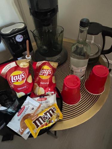 a table with chips and snacks on a table with a blender at Cosy by Mandy in Amsterdam