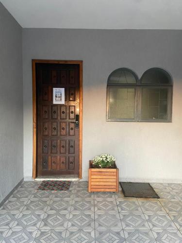 a door of a house with a plant in front of it at Casa do Loro Hospedagem in Curitiba