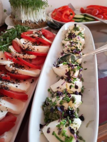 a plate of appetizers with vegetables on a table at Kleinhofers Himbeernest in Anger