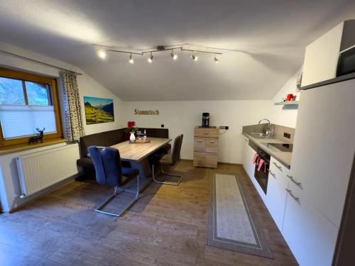 a kitchen with a table and chairs in a room at Apart Eberharter in Aschau