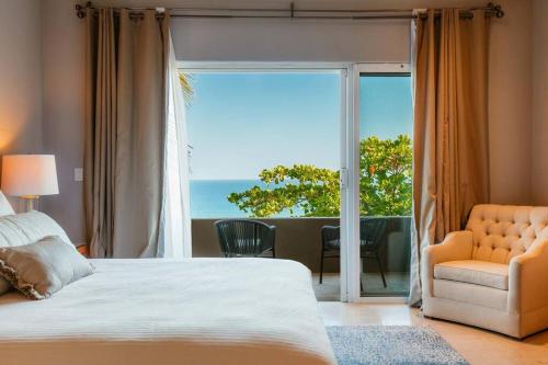 a bedroom with a bed and a view of the ocean at Casa de las Olas - Villa Ocean View in San José del Cabo