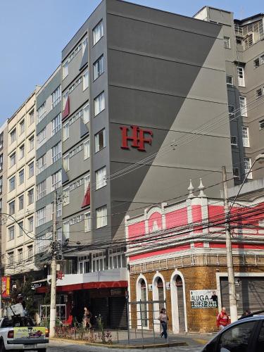 a large building with the hf sign on it at Hotel Fabris in Nova Friburgo