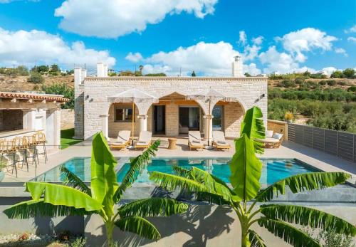 a villa with a swimming pool and a patio at Elegant Villa with Pool & Views in Áptera