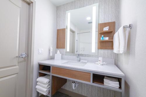 a bathroom with a sink and a mirror at Hilton Garden Inn Lakewood in Lakewood