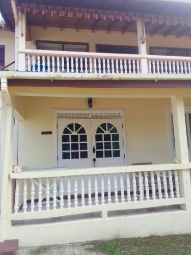 a house with a porch and a balcony at Chalet Belizomi Tropical Villas No #2 in Rodney Bay Village