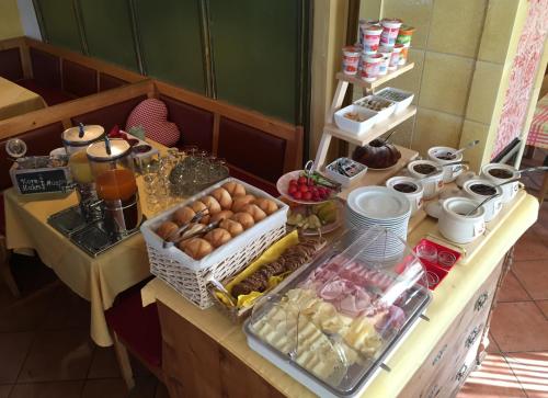 a table with a bunch of food on it at Landgasthof Lenzer in Strassen