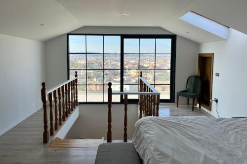 a bedroom with a bed and a large window at Garden Hill Villa Durres in Durrës