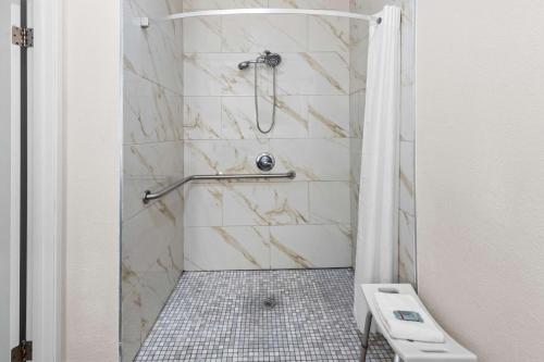 a bathroom with a shower with a toilet at Best Western Worlds Of Fun in Kansas City