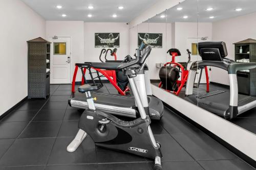 a gym with two exercise bikes and a treadmill at Best Western Worlds Of Fun in Kansas City