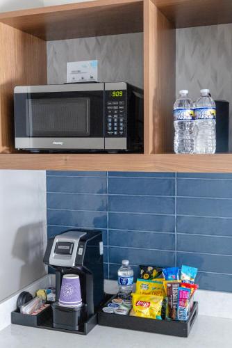 a microwave oven sitting on a shelf with food at Hilton Garden Inn Lakewood in Lakewood