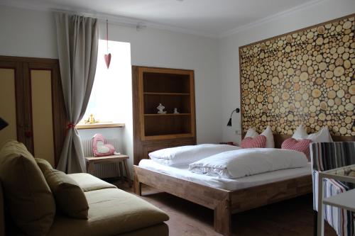1 dormitorio con 2 camas y sofá en Landgasthof Lenzer en Strassen