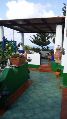 a patio with potted plants and a roof at Aquilone Residence in Stromboli