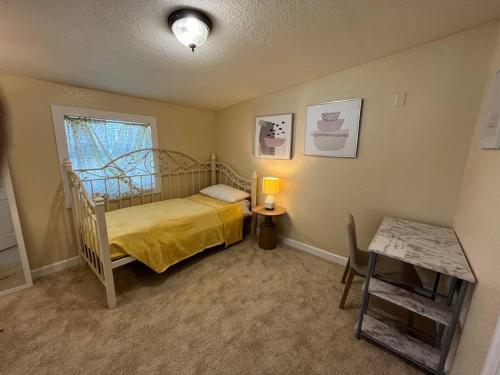 a small bedroom with a bed and a table at Maison Pierre in Jacksonville