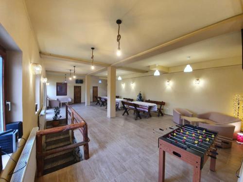 a living room with a foos ball on a table at PENSIUNEA LEIA Transfăgărășan in Cîrţişoara