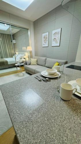 a living room with a couch and a table at Apart - Highvill, Хайвилл in Promyshlennyy