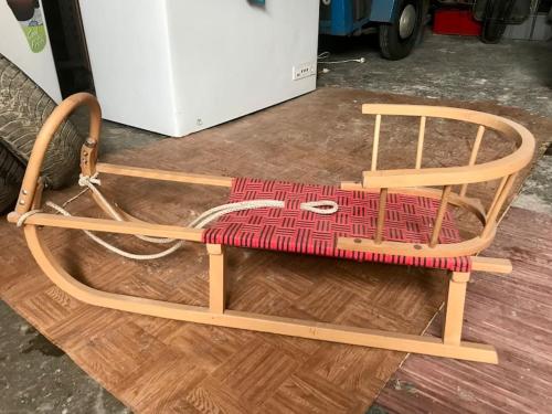 a wooden chair sitting on top of a wooden floor at Vila 100klasa in Nejdek