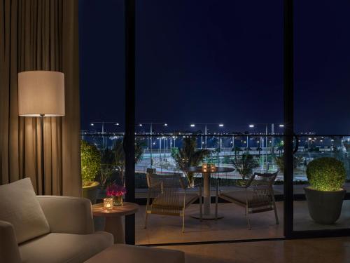 a living room with a view of the ocean at night at The Jeddah EDITION in Jeddah