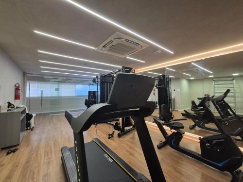 a gym with treadmills and exercise bikes in a room at Transamerica Dunas de Marapé in Jequia da Praia
