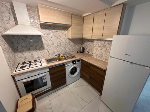 a kitchen with a stove and a white refrigerator at Kyrenia center, 2 bedroom, 1 living room, residential apartment in Kérynia