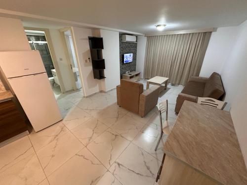 a living room with a couch and chairs and a television at Kyrenia center, 2 bedroom, 1 living room, residential apartment in Kérynia