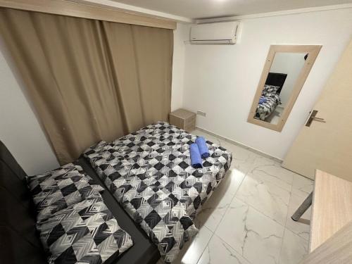 a bedroom with a bed and a mirror in it at Kyrenia center, 2 bedroom, 1 living room, residential apartment in Kérynia