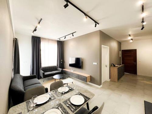 a living room with a table and chairs and a television at Unit 310 in Quatre Bornes