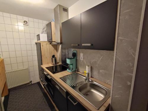 a small kitchen with a sink and a counter at Haus Carmen Kleboth in Gaschurn