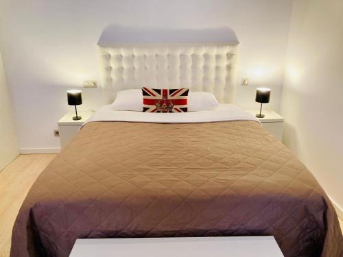 a large bed in a bedroom with two lamps at Royal Residence in Old Town in Staré Mesto